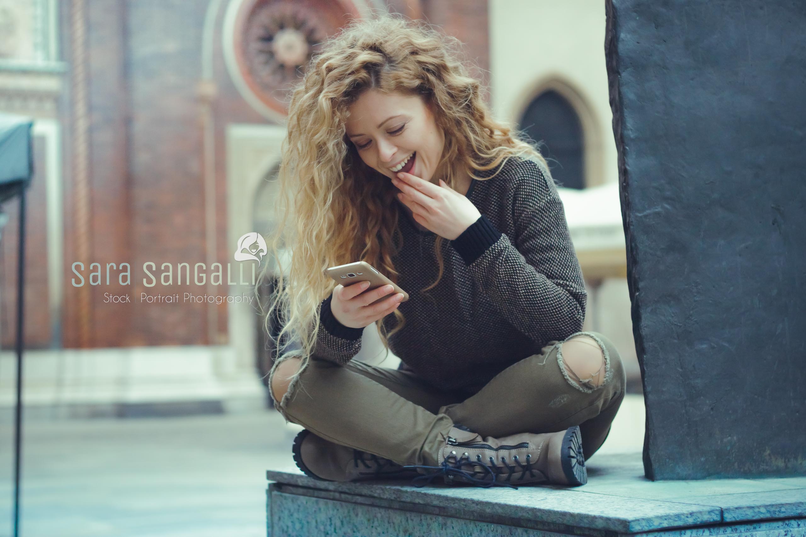 young blonde woman chatting on her smartphone